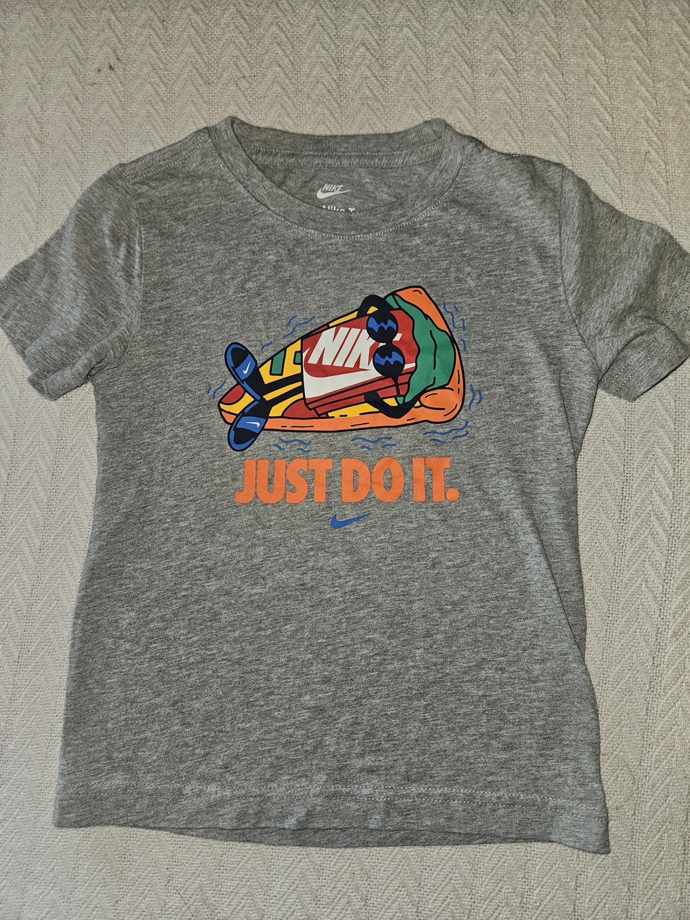 Nike Kids Grey Tee with Multicolor Boat Graphic and Orange Slogan